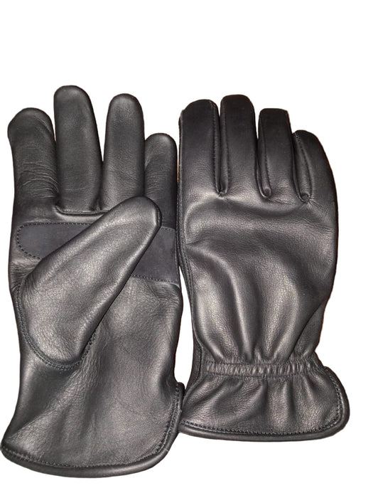 Pair of black leather gloves on a wooden surface